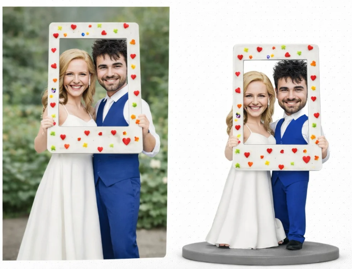 Smiling bride and groom hold a white frame decorated with colorful hearts outdoors.