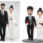 Real couple in black-and-white formal attire, holding hands, shown next to their cartoon bobblehead replicas on a round pedestal with red props, both smiling.