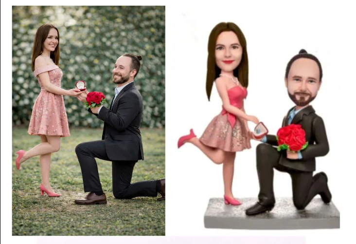 A man proposing on one knee to a woman in a pink dress outdoors, offering a ring and bouquet; a cartoon version of the couple stands beside them.
