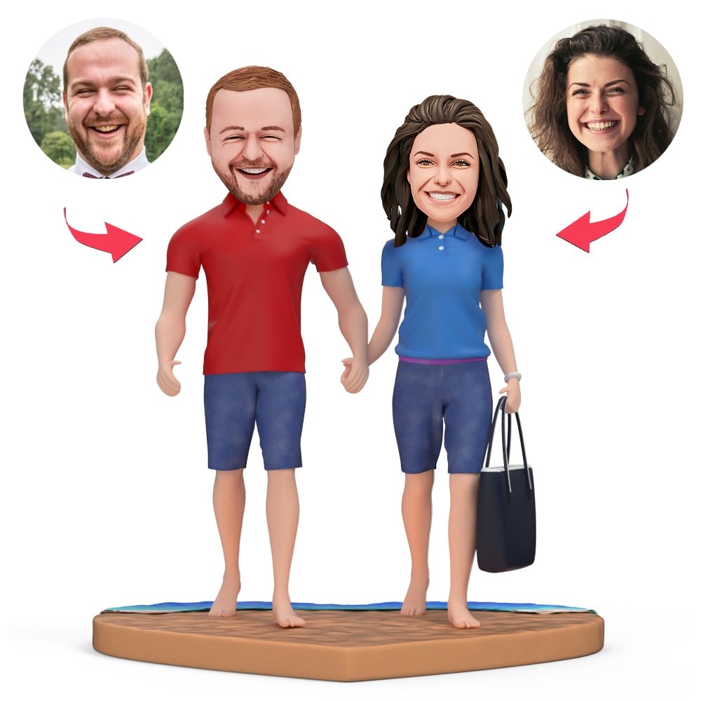 Real couple at the beach holding hands, dressed in red and blue polo shirts with a black tote bag nearby.