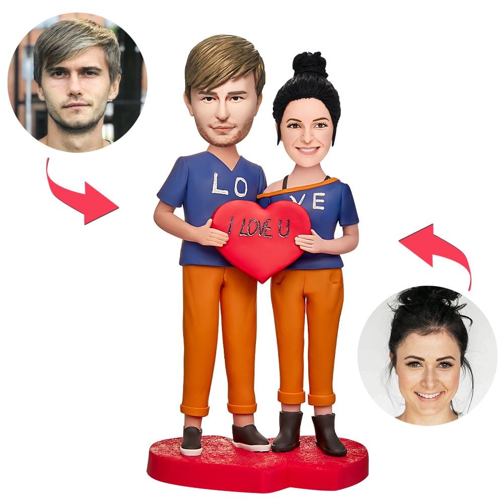 Custom couple bobblehead holding an I Love You heart created from customer photos