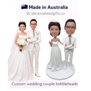 Custom wedding couple bobbleheads — bride and groom figurines in wedding attire.
