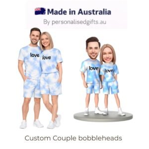 Custom couple bobbleheads in matching blue tie-dye outfits with 'love' text, shown with a real couple.