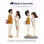 Custom couple bobblehead figurines: a man and woman facing each other, holding gifts, with a 'Made in Australia' banner above, captioned 'Custom Couple bobbleheads'.