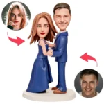Custom couple bobbleheads in blue formal wear dancing, with circular photos of the real people connected by arrows on a white background.