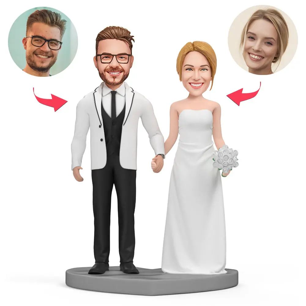 Customized wedding cake topper: bride and groom figurines on a round base with circular portrait heads and red arrows pointing to each portrait.