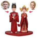 Two cartoon Chinese wedding dolls in red robes holding hands on a red platform, with round headshots of a man and a woman linked by arrows.