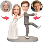 Cartoon wedding cake topper: bride and groom dancing on a round base, with four guest faces in circles above the couple.