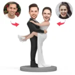 Cartoon wedding statue: groom in black suit carries bride in a white dress on a pedestal; circular photo portraits of a man (left) and a woman (right) connected by red arrows.
