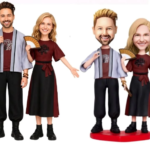 Four cartoon-style figurines: two adults and two smaller figures, dressed in maroon tops and black skirts/pants, holding fans.