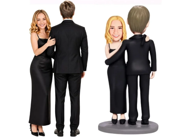 Left: a smiling woman in a black formal dress and a man in a black suit stand with their backs turned to the camera; right: two cartoon bobblehead figures in black attire hug on a small pedestal.