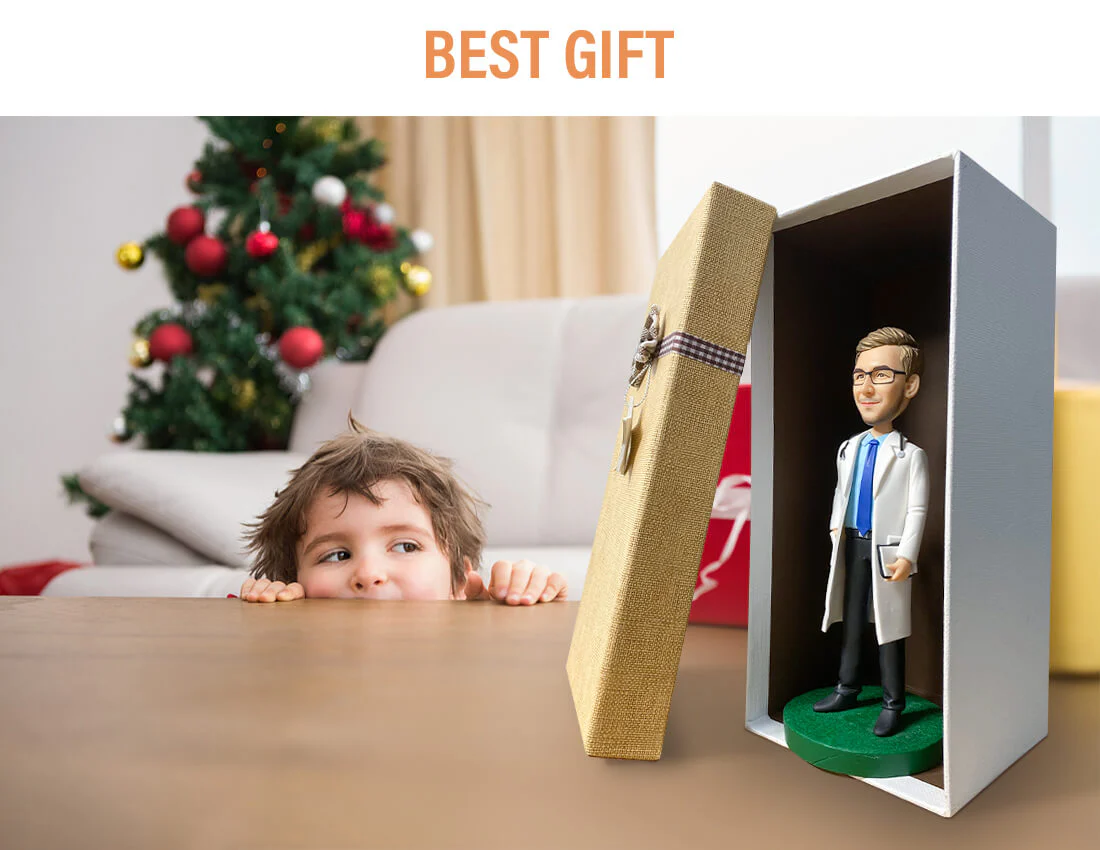Child peeks at an open gift box revealing a doctor figurine inside, with a Christmas tree in the background and 'BEST GIFT' heading above.