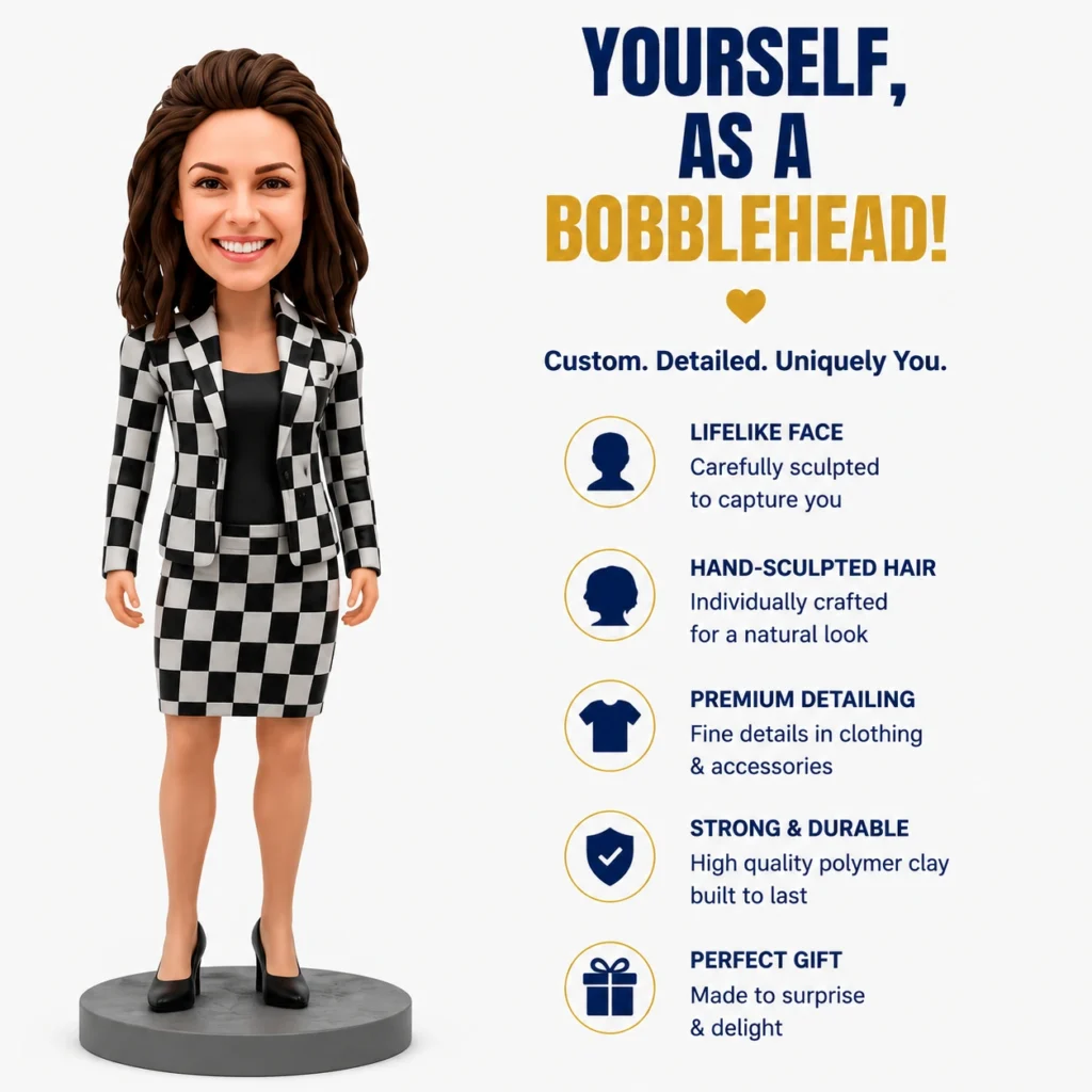 Bobblehead-style figure of a woman in a black-and-white checkered suit standing on a gray pedestal next to an infographic that reads 'YOURSELF, AS A BOBBLEHEAD!' with a heart icon and five features listed (life-like face, hand-sculpted hair, premium detailing, strong & durable, perfect gift).