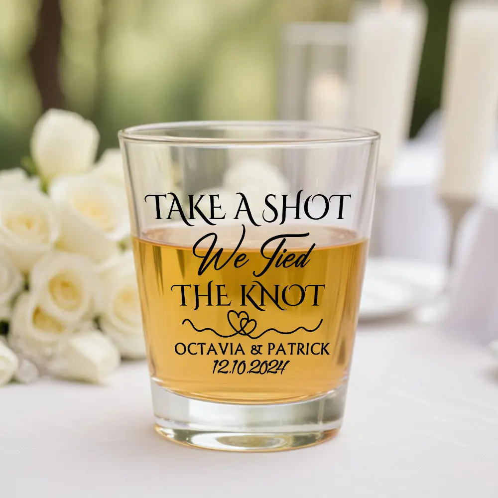 Wedding toast glass engraved with 'Take a shot, We tied the knot' and 'Octavia & Patrick, 12.10.2024'