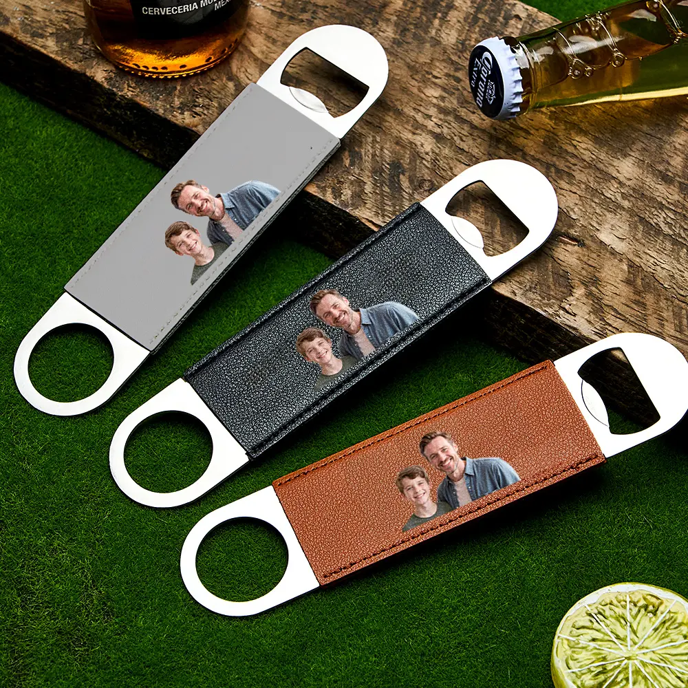 Leather-wrapped bottle openers with a printed family photo on the strap, shown in grey, black, and brown styles on a wooden and grass background (customizable gift).