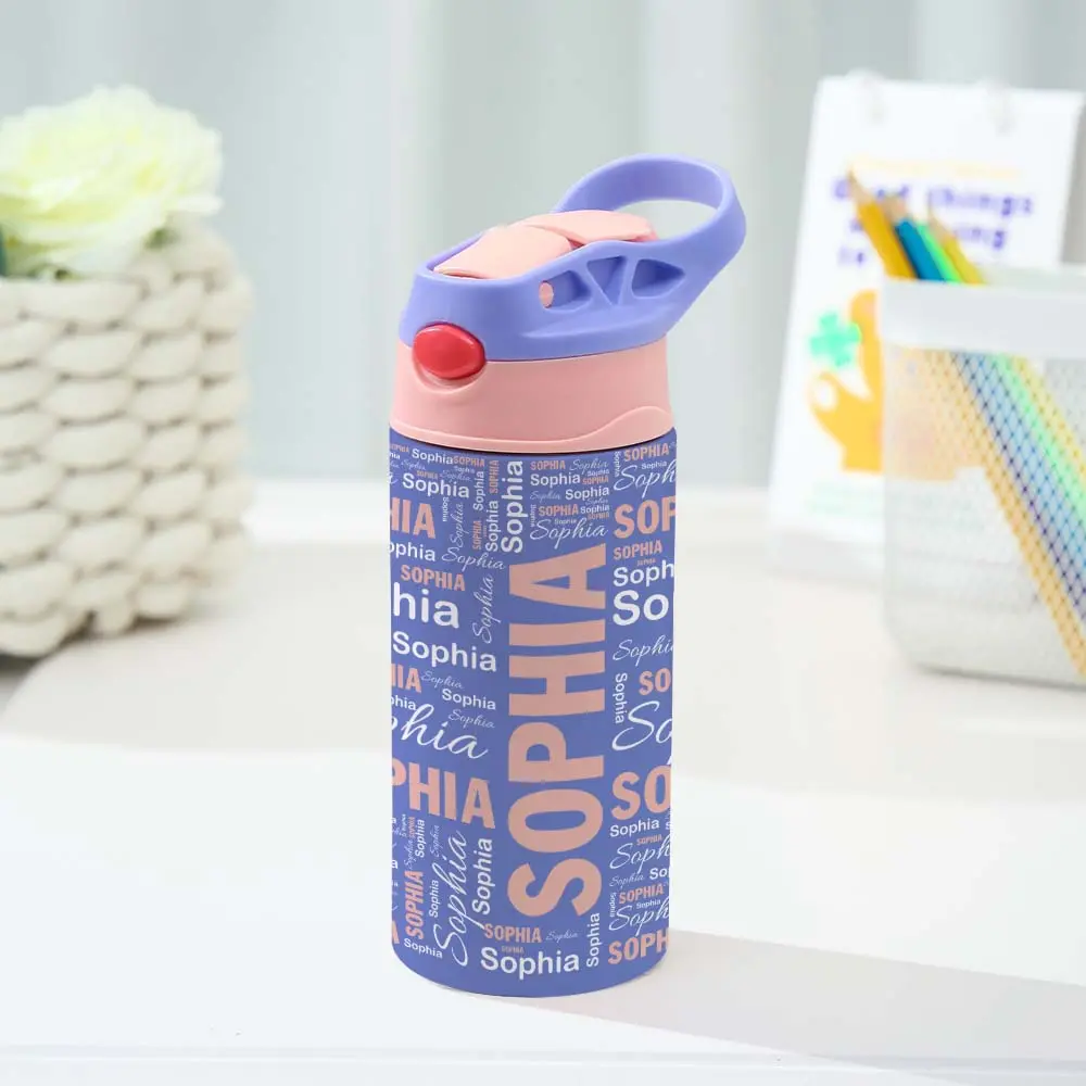 Personalized blue and pink kids water bottle with 'Sophia' repeated in various fonts, on a desk.
