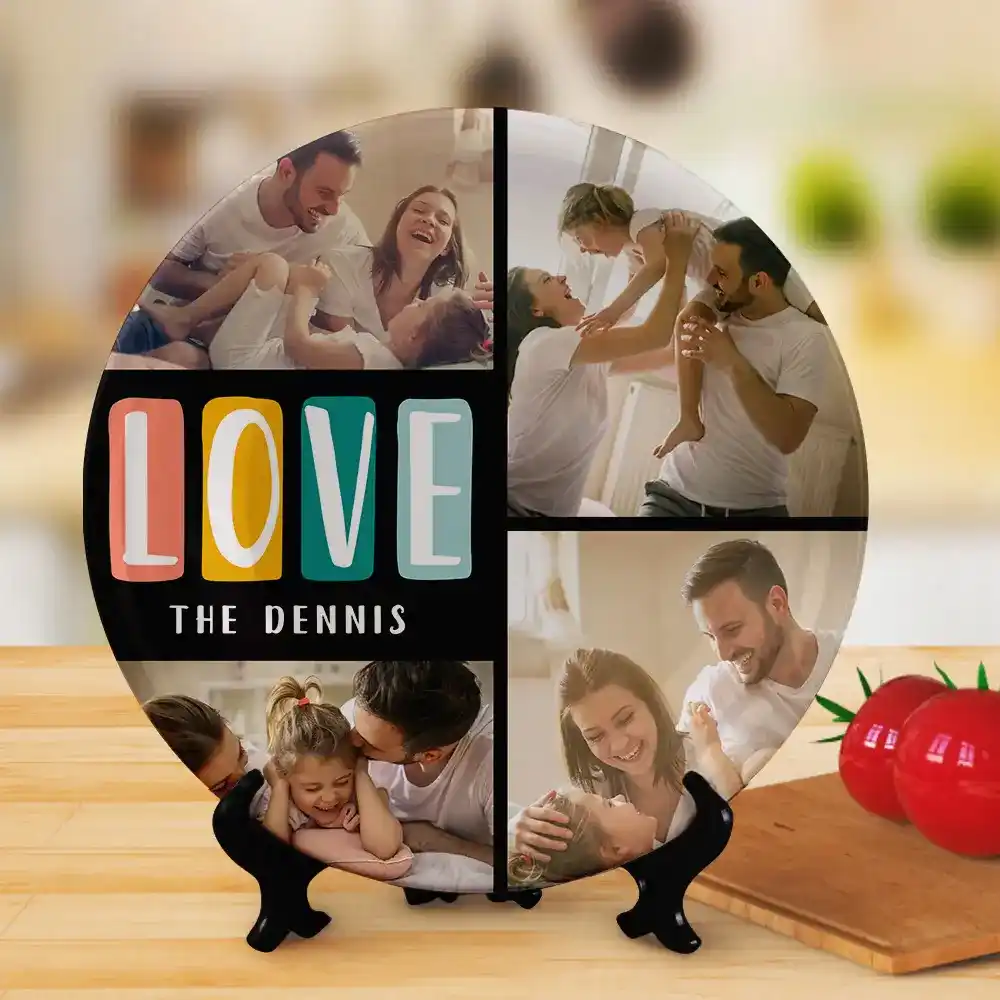Round photo collage of a joyful family moment, with colorful 'LOVE' letters and 'THE DENNIS' text on a black panel, placed on a wooden surface.