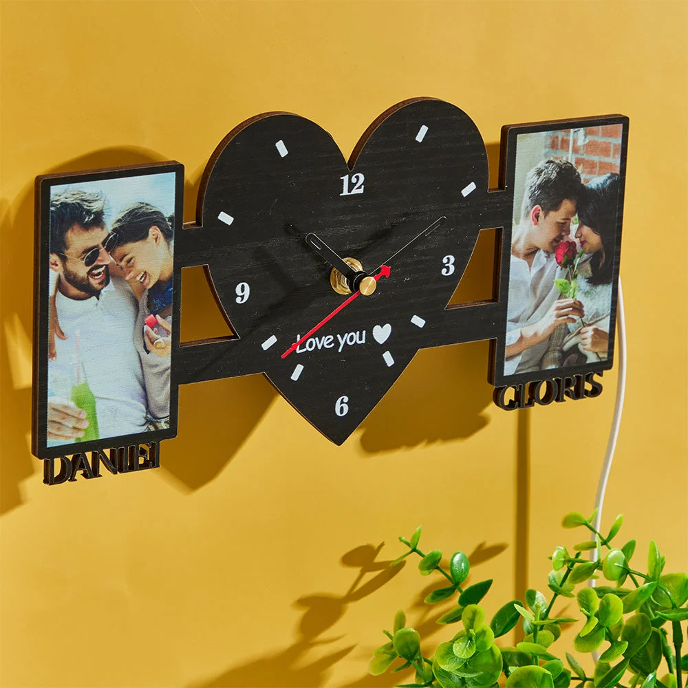 Heart-shaped central clock flanked by two photo frames of a couple, with 'Love you' text at bottom and names 'DANIEL' and 'CLORI S' on frames.