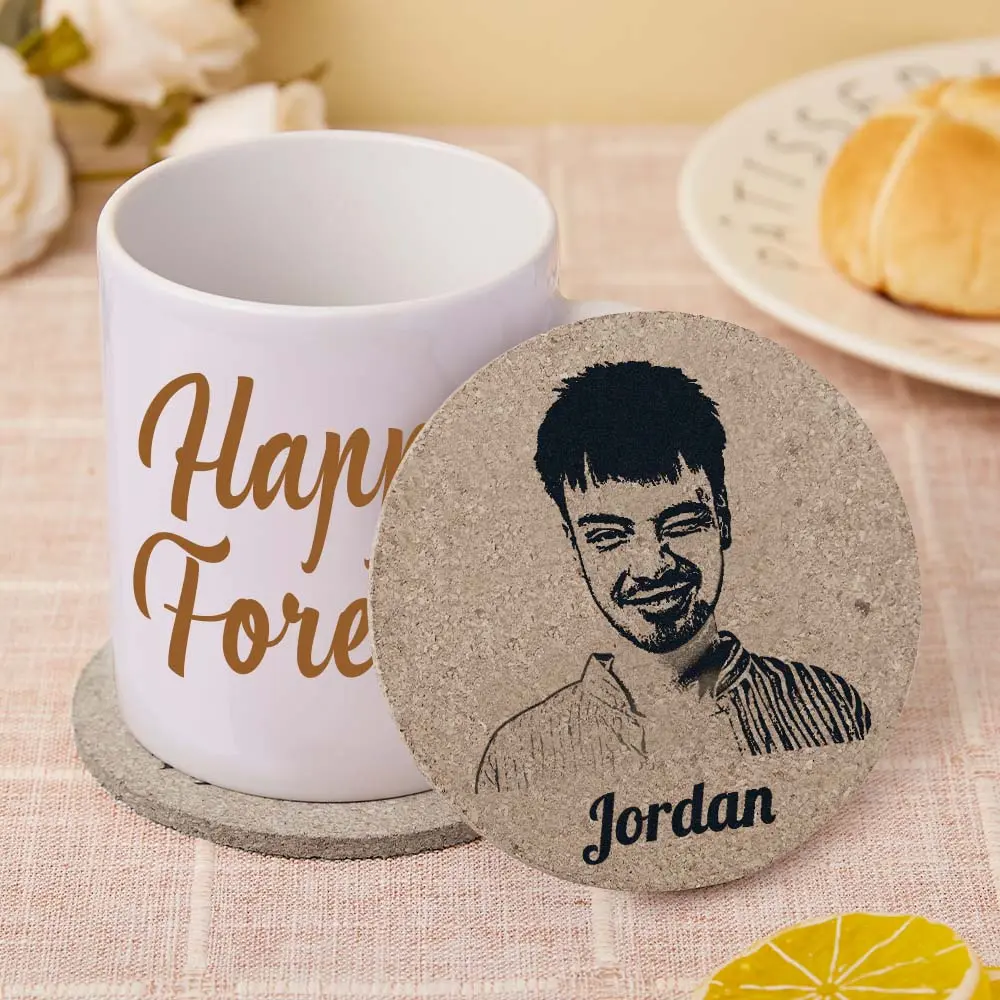 White mug with gold script 'Happy Forever' next to a round cork coaster featuring a smiling man’s sketch and the name Jordan.