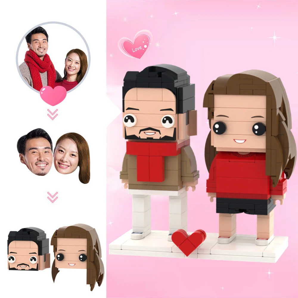 Valentine-themed display: brick-built couple in red on a white base with a red heart, pink sparkly background.