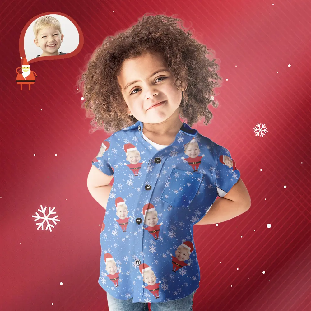 Smiling young child wearing a blue shirt with Santa graphics, posing with hands behind back against a red festive background with snowflakes.