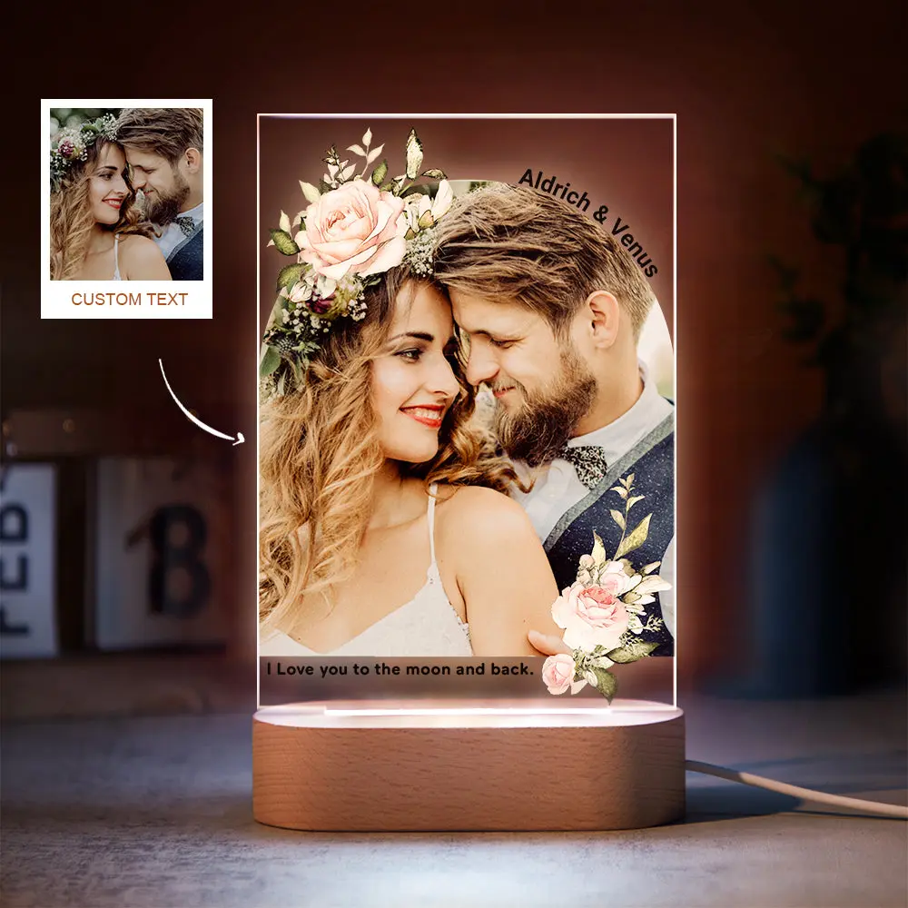 Illuminated acrylic photo of a couple with flowers and the caption 'I love you to the moon and back'.