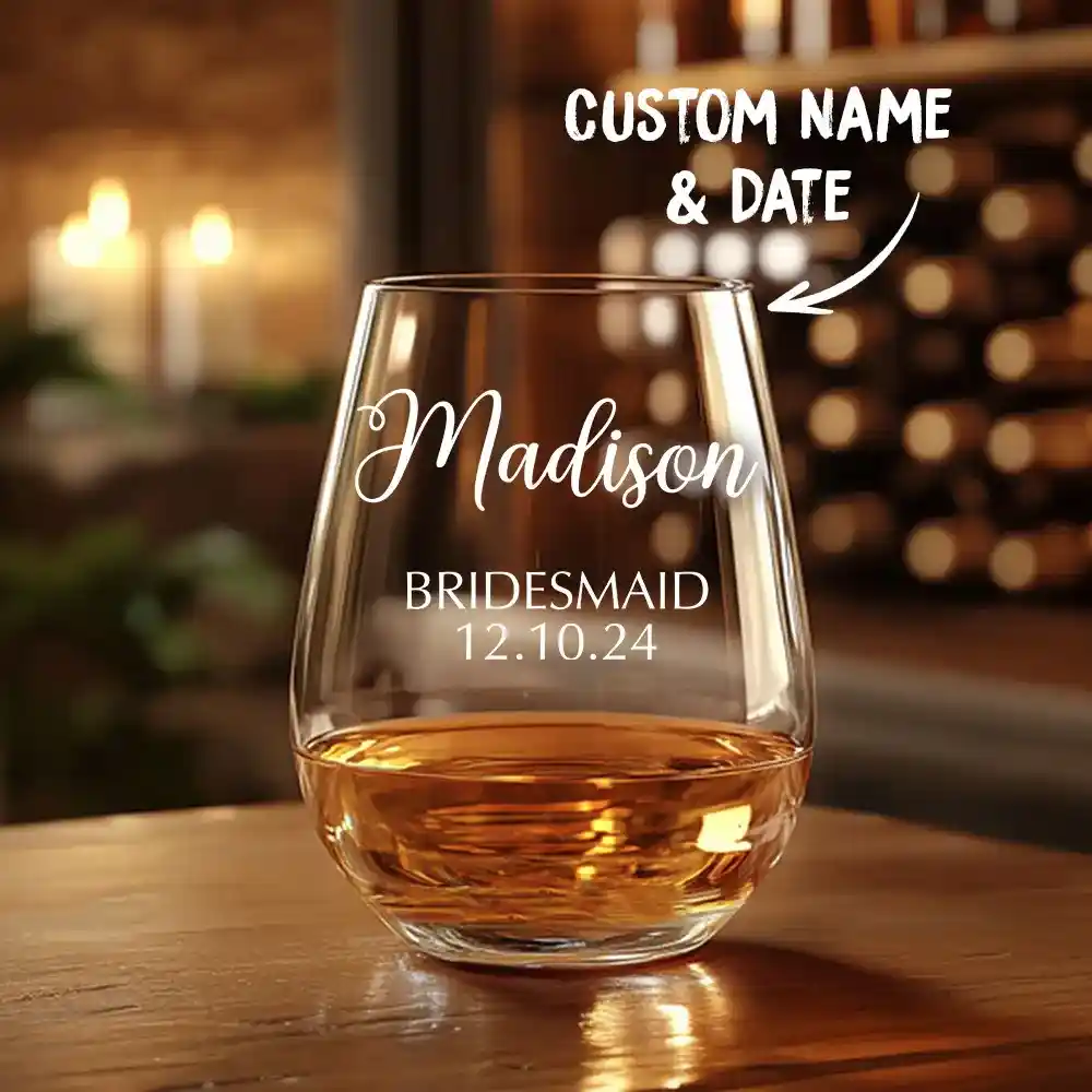 Glass tumbler with amber whiskey, engraved 'Madison' and 'Bridesmaid 12.10.24' (custom name & date).
