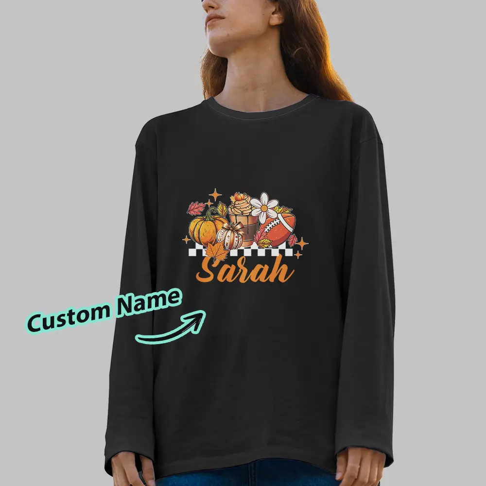 Black sweatshirt with a fall-themed graphic featuring pumpkins, flowers, and a customizable name in orange script (e.g., 'Sarah').