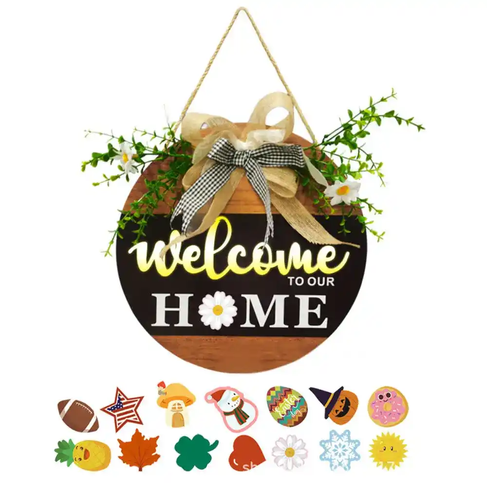 Rounded wooden hanging sign that reads 'Welcome to Our Home' with a beige bow and greenery, hanging from a rope; colorful Easter stickers (stars, eggs, flowers) arranged below.