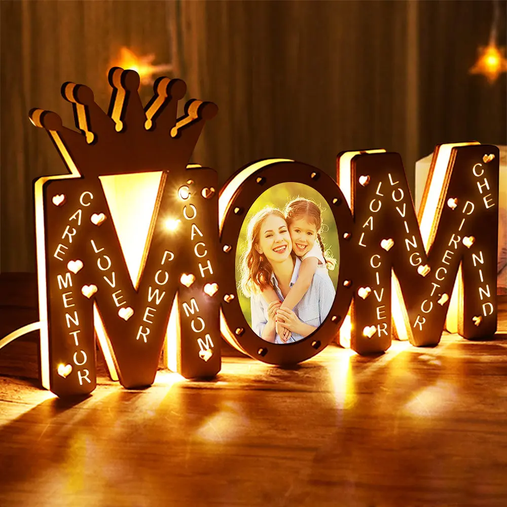 Marquee LOVE sign with a crown on top, glowing warm lights, and a photo of a mother and child in the O.