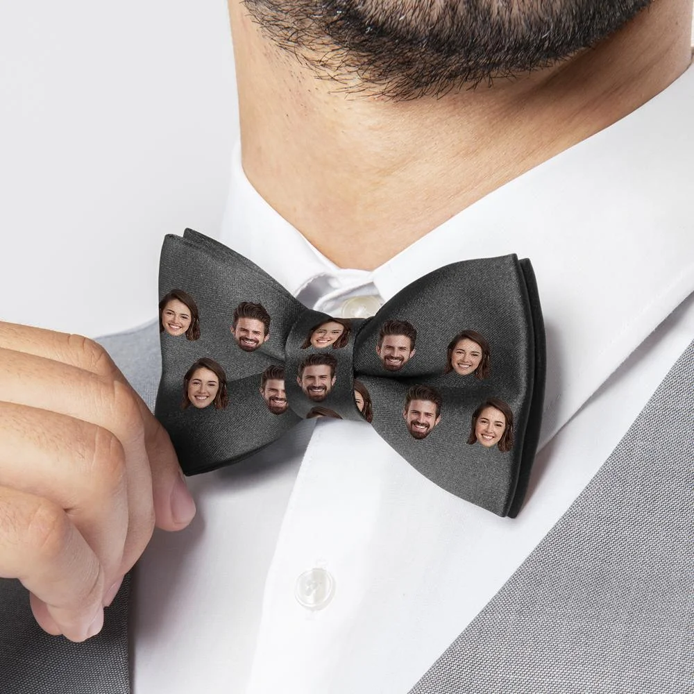 Gray bow tie covered in repeating small portrait faces, being adjusted by a hand.