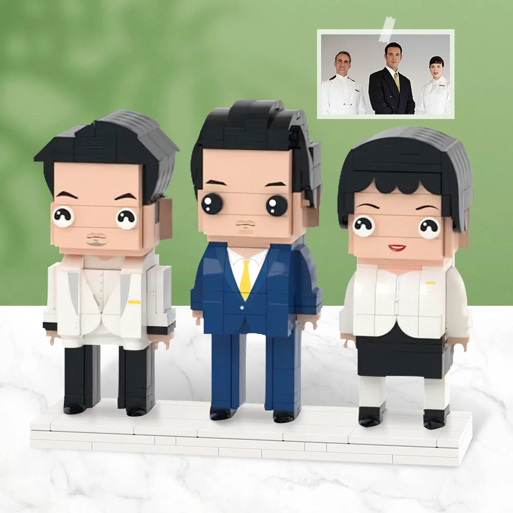 Three LEGO-style business figurines (two men in suits and a woman in a white jacket) stand on a white display base.