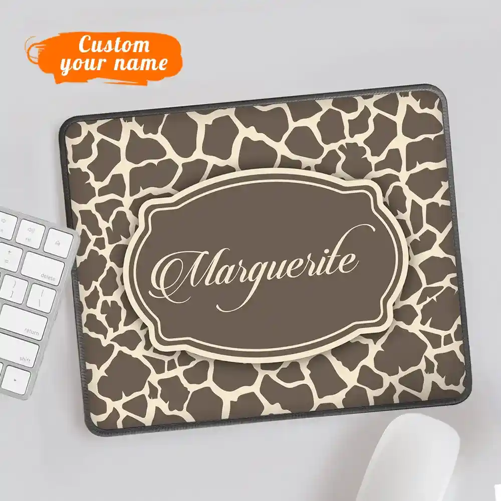 Giraffe-print laptop sleeve with a brown central badge reading 'Marquerite' and an orange 'Custom your name' label above.