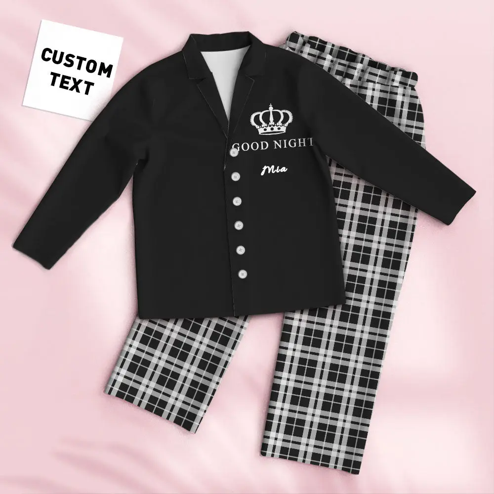 Black buttoned top with crown emblem and 'GOOD NIGHT Mia' text, paired with black-and-white plaid pants on a pink backdrop (custom text card).​