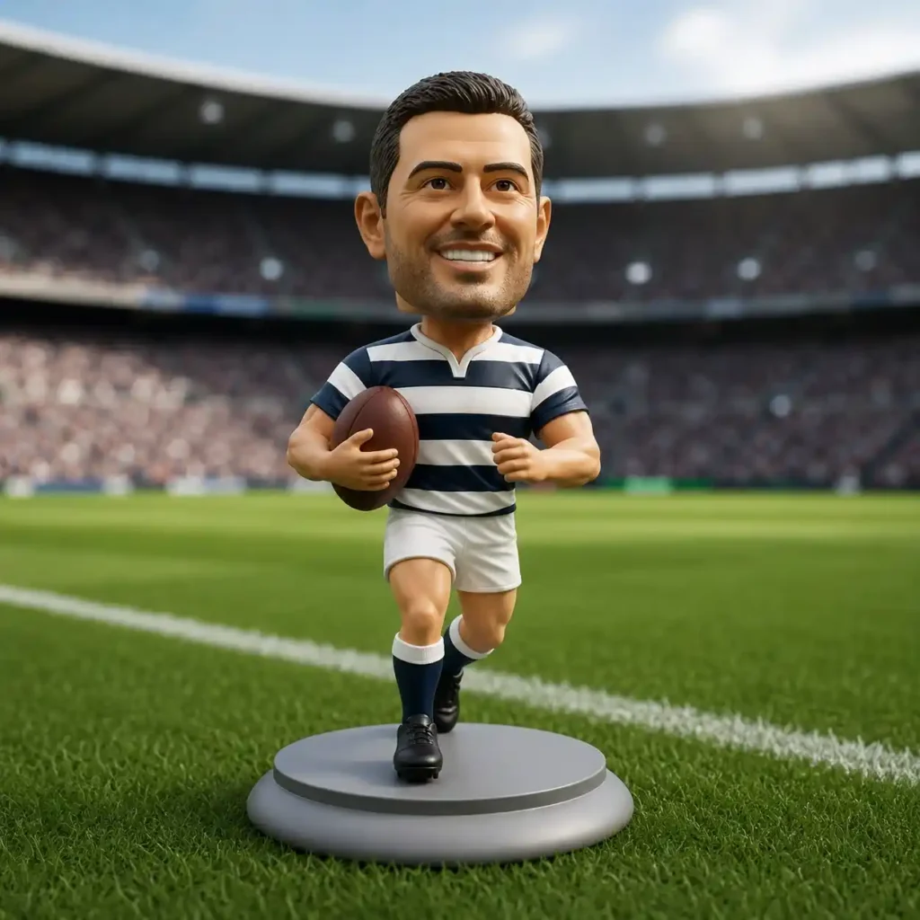 Bobblehead-style rugby player figurine running with a rugby ball on a pedestal in a stadium setting