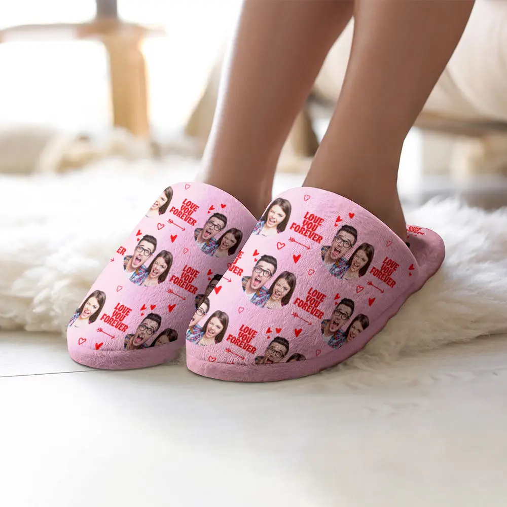Pink slippers with a photo collage of a couple's faces and 'LOVE YOU FOREVER' text, worn on feet indoors.