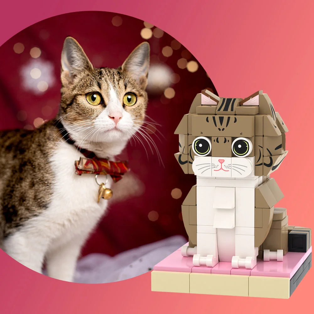 Real tabby cat with a red bow beside a brick-built LEGO cat on a pink pedestal against a pink gradient background.