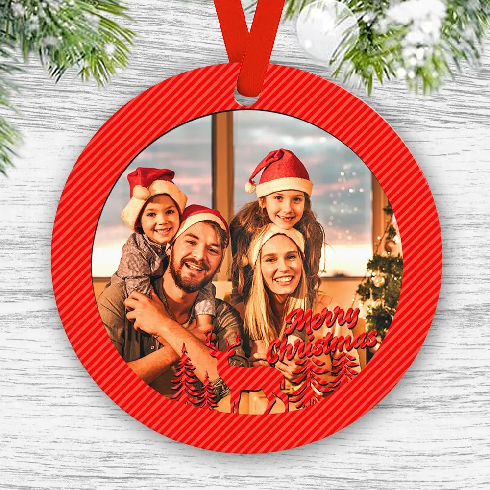 Round red Christmas ornament framing a family portrait wearing Santa hats, with 'Merry Christmas' and silhouette trees inside.
