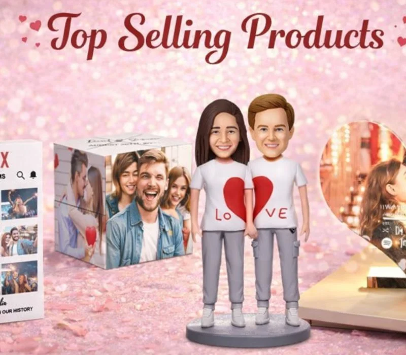 Promotional collage with two cartoon couple figurines wearing love-themed shirts, standing on a display against a pink, glittery background and the text 'Top Selling Products' above.