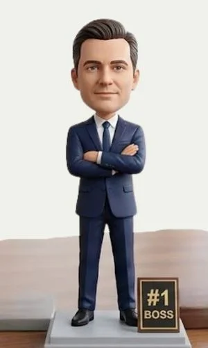 Bobblehead-style businessman in a navy suit with arms crossed, standing on a small podium beside a '#1 BOSS' plaque on a desk.