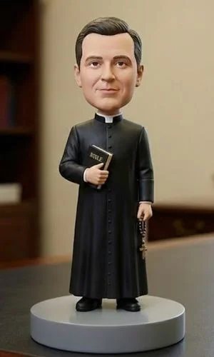 Bobblehead priest in a black cassock on a gray base, holding a Bible and rosary.