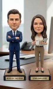Two bobblehead-style figures on an office desk labeled 'Boss of the Year' and 'Star Employee'.