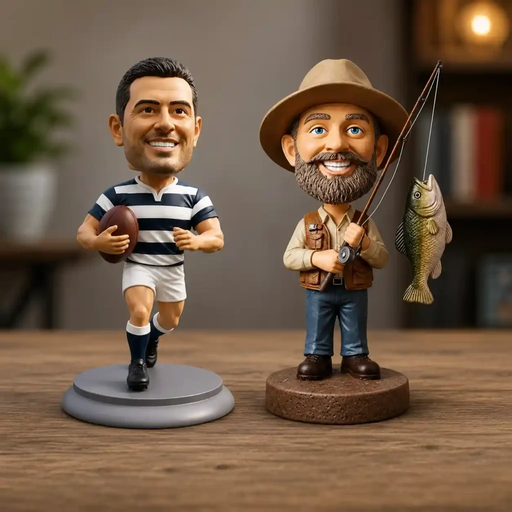 Two bobblehead figurines stand on a wooden table: a rugby player with a ball and a fisherman with a rod and a fish.