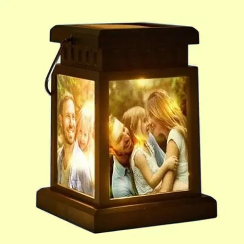 Photo lantern with two illuminated panels showing a family moment and a couple hugging, decorative keepsake lighting