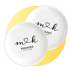 Two white circular tokens overlap on a yellow background, each reading 'Engaged' with a heart and the date 05-22-2022.