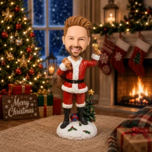 Santa bobblehead in a red suit with a raised fist, standing on a snowy base amid a festive living room (tree, gifts, stockings, and a lit fireplace).