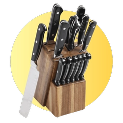 Wooden knife block with multiple stainless steel kitchen knives on a yellow background.
