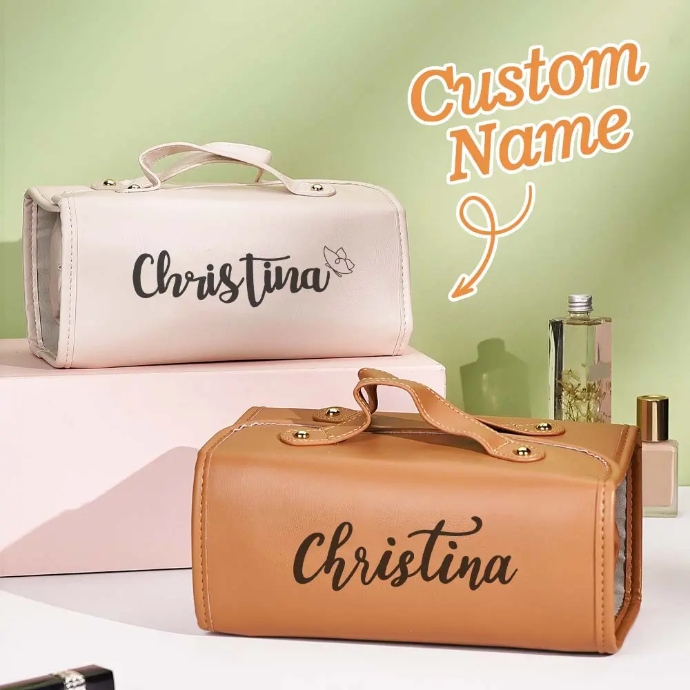 Two personalized cosmetic bags with the name Christina, white and tan, on a pastel backdrop.