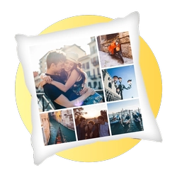 Decorative white pillow with a photo collage of a couple and travel moments, placed in front of a yellow circular backdrop.