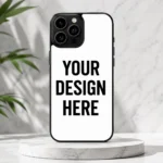 Smartphone with a white back showing bold text 'YOUR DESIGN HERE' on a marble pedestal.